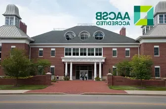 exterior photo of COBE with AACSB logo overlay